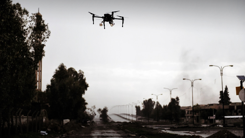 A drone carrying two grenades flies over the northern Iraqi city of Mosul. (Photo: Getty Images)