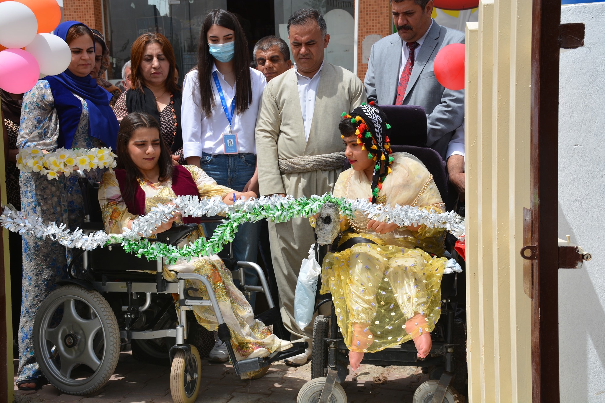 Two residents of Halabja cut a ribbon to mark the opening of Khoshy park in the Khurmal district, June 20, 2021. (Photo: Halabja Disabled Organization/Facebook)