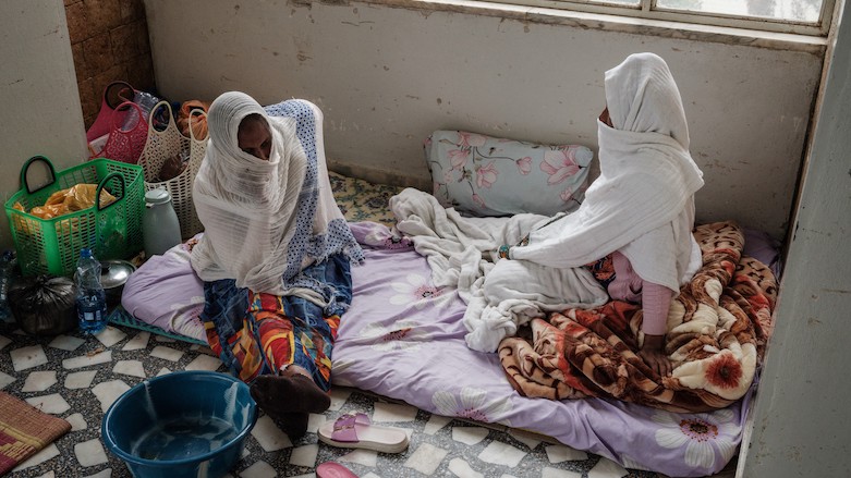 A woman (R) stays with her family’s help on the floor for 11 days after delivering a baby due to the lack of beds at Ayder Referral Hospital in Mekele, capital of the Tigray region, Ethiopia, June 20, 2021. (Photo: Yasuyoshi Chiba/AFP)