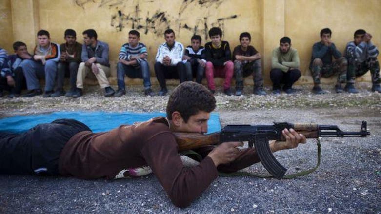 Syrian youth Sobhi, 15, holds an AK-47 assault rifles as he takes part in a military training at a former school turned into a “military academy” in Tallinn in Aleppo province, Syria, Jan. 23, 2013 (Photo: JM Lopez/AFP)