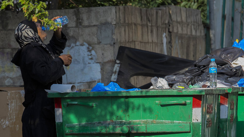A homeless woman drinks water from a garbage dumpster in Beirut, Lebanon, July 23, 2020. The World Bank said in June 2020 Lebanon’s economic crisis is likely the worst in the world in 150 years. (Photo: Hassan Ammar/AP)