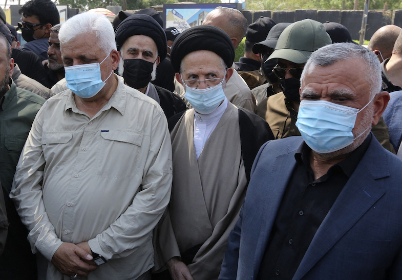Al-Fateh Front leader Hadi al-Amiri (right) and Popular Mobilization Authority Faleh al-Fayyad head (left) at a symbolic funeral organized by the PMF on June 29, 2021, for those killed in a US strike. (Photo: Sabah Arar/AFP)