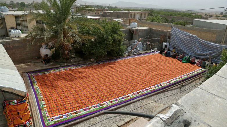 Iranian women work on weaving the largest kilim in the world in Qirokarzin, in the southern Fars province (Photo: Farzaneh Chakhmagh Zas/Iran's Young Journalists Club/AFP)