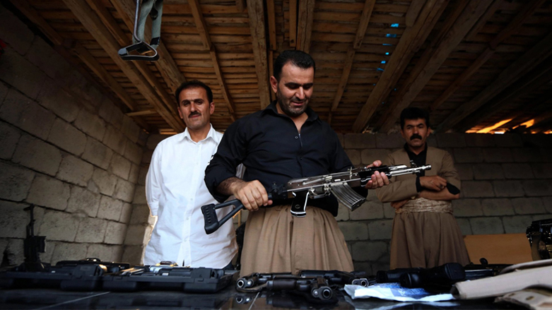 A man inspects a firearm in one of the Kurdistan Region's arms market in Erbil, Aug. 17, 2014. (Photo: Safin Hamed/AFP)