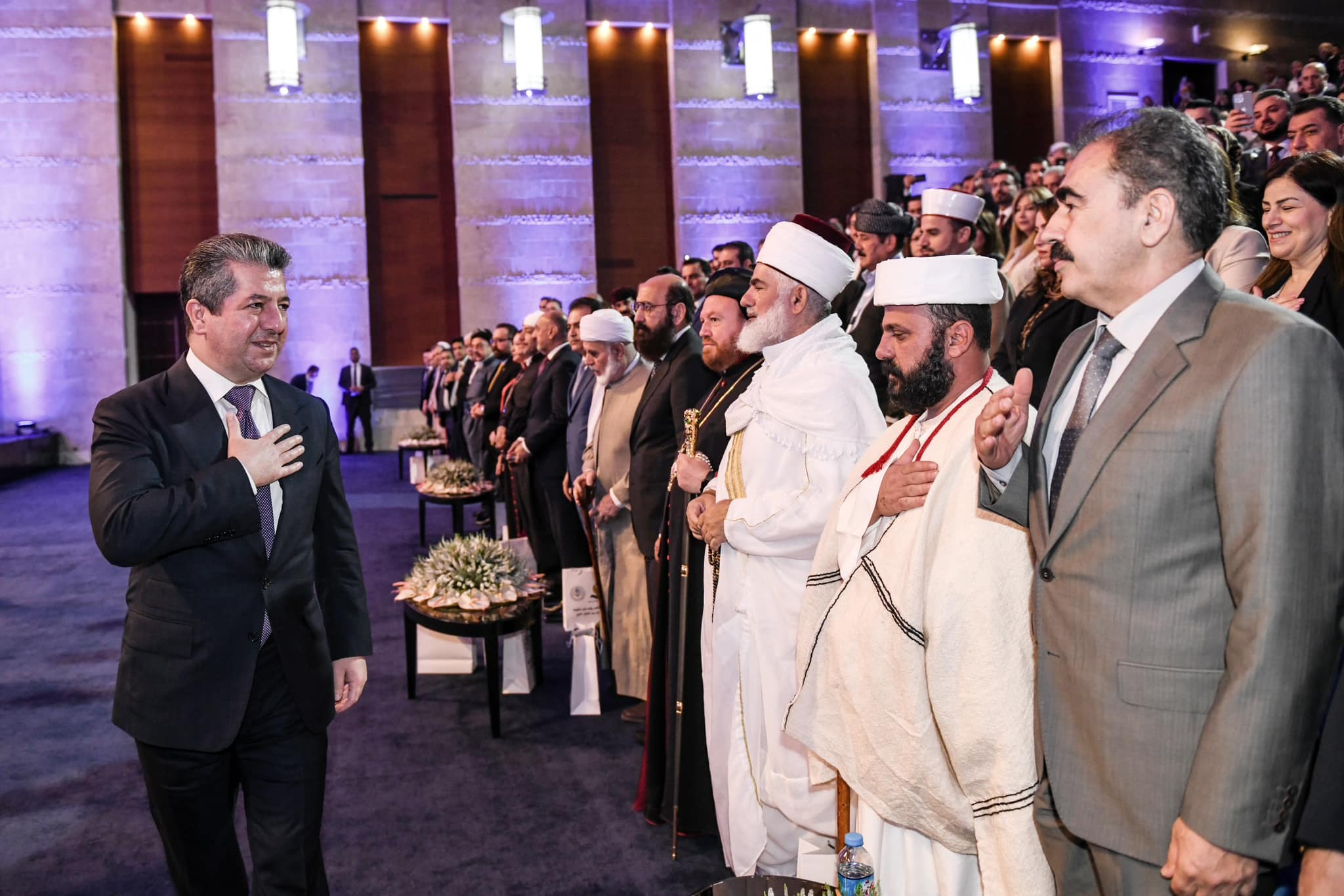 Kurdistan Region Prime Minister Masrour Barzani greeting attendees, including religious leaders, at Kurdistan: Cradle of Peaceful coexistence conference in Erbil, June 18, 2023. (Photo: KRG)
