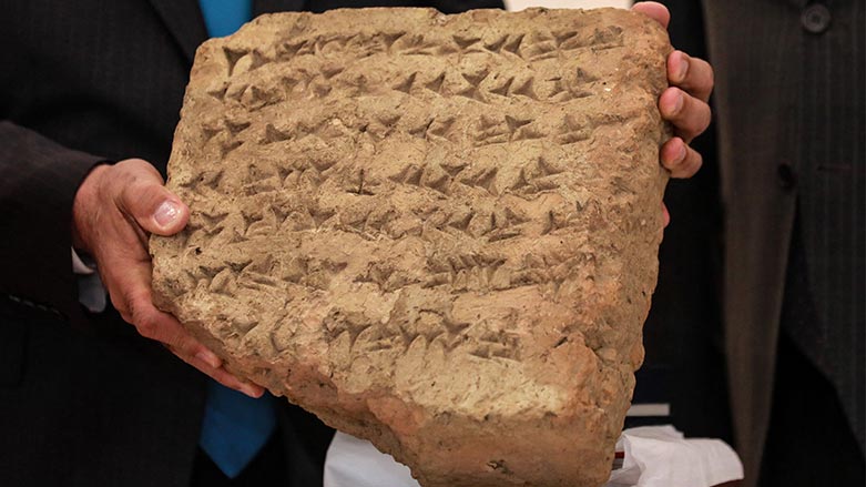 A 2,800-year-old stone tablet is presented during a press conference in Baghdad, after it was handed over by the Italian authorities to the Iraqi president during his recent visit to Bologna, on June 18, 2023. (Murtaja Lateef/ AFP)