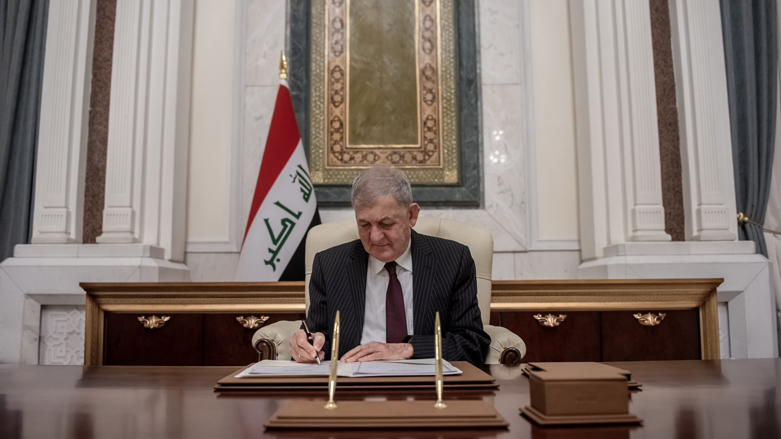 Iraqi President Abdul Latif Rasheed is pictured while signing the country's 2023-2025 budget bill into law, June 21, 2023. (Photo: Iraqi Presidency media)