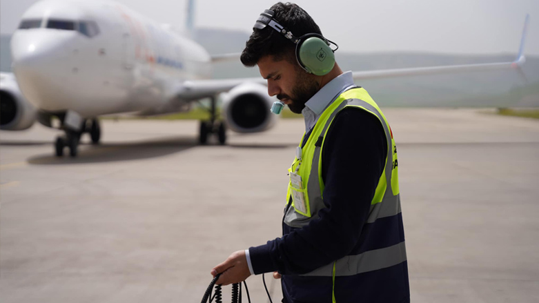 An aircraft handler is pictured near a parked airplane at Sulaimani International Airport, April 9, 2023. (Photo: Azmar Airlines)