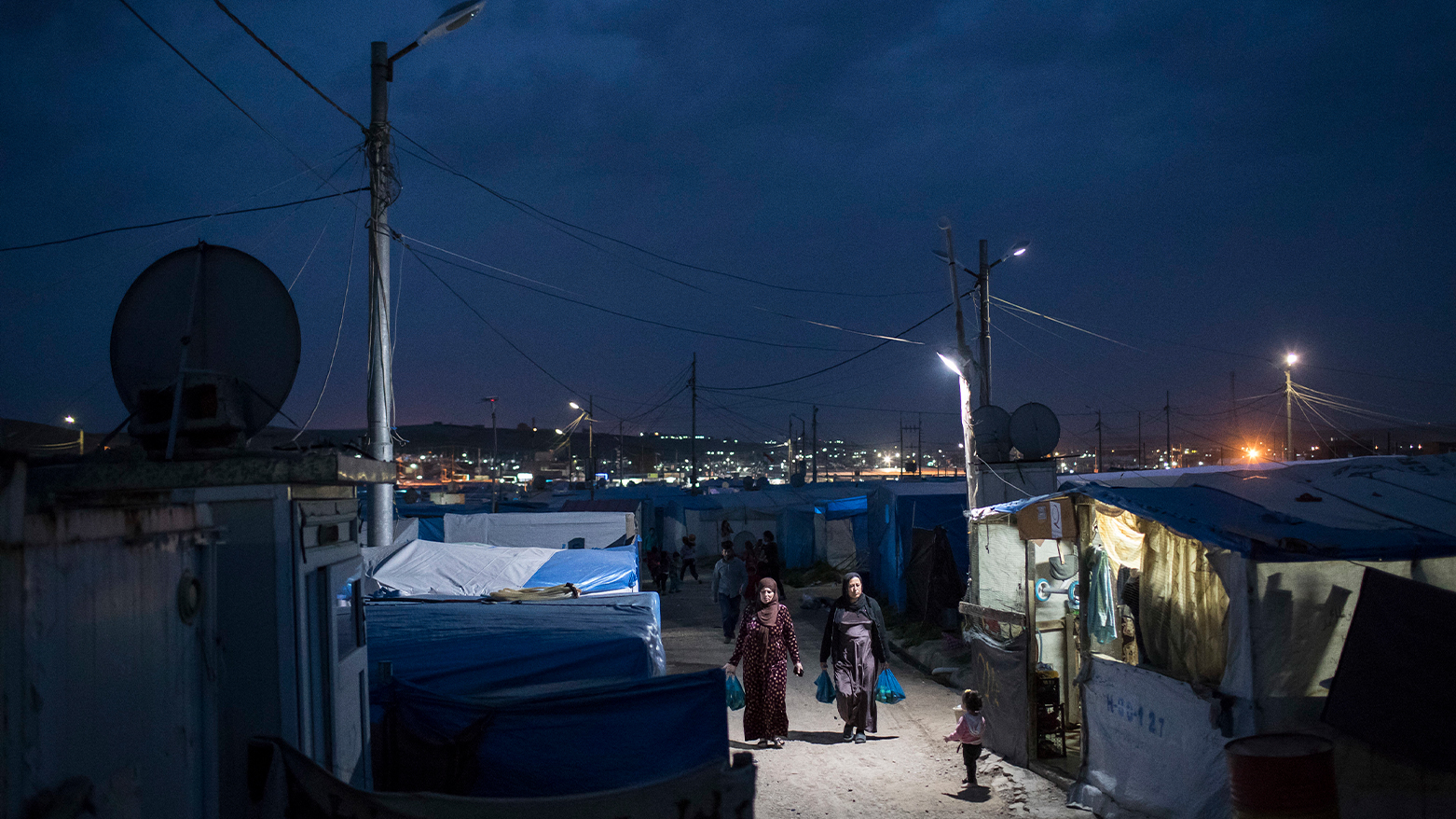 Women walk through the Kawergosk refugee camp in Kurdistan Region. (Photo: AP)