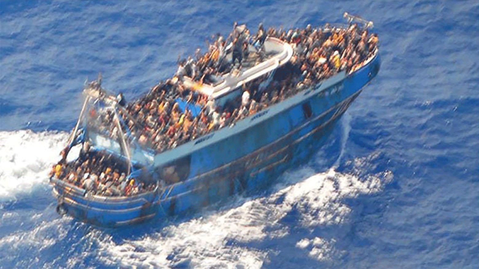 An aerial view taken from a rescue helicopter, of migrants onboard a fishing vessel in the waters off the Peloponnese coast of Greece on June 13, 2023. (Photo: The Hellenic Coastguard/ AFP)