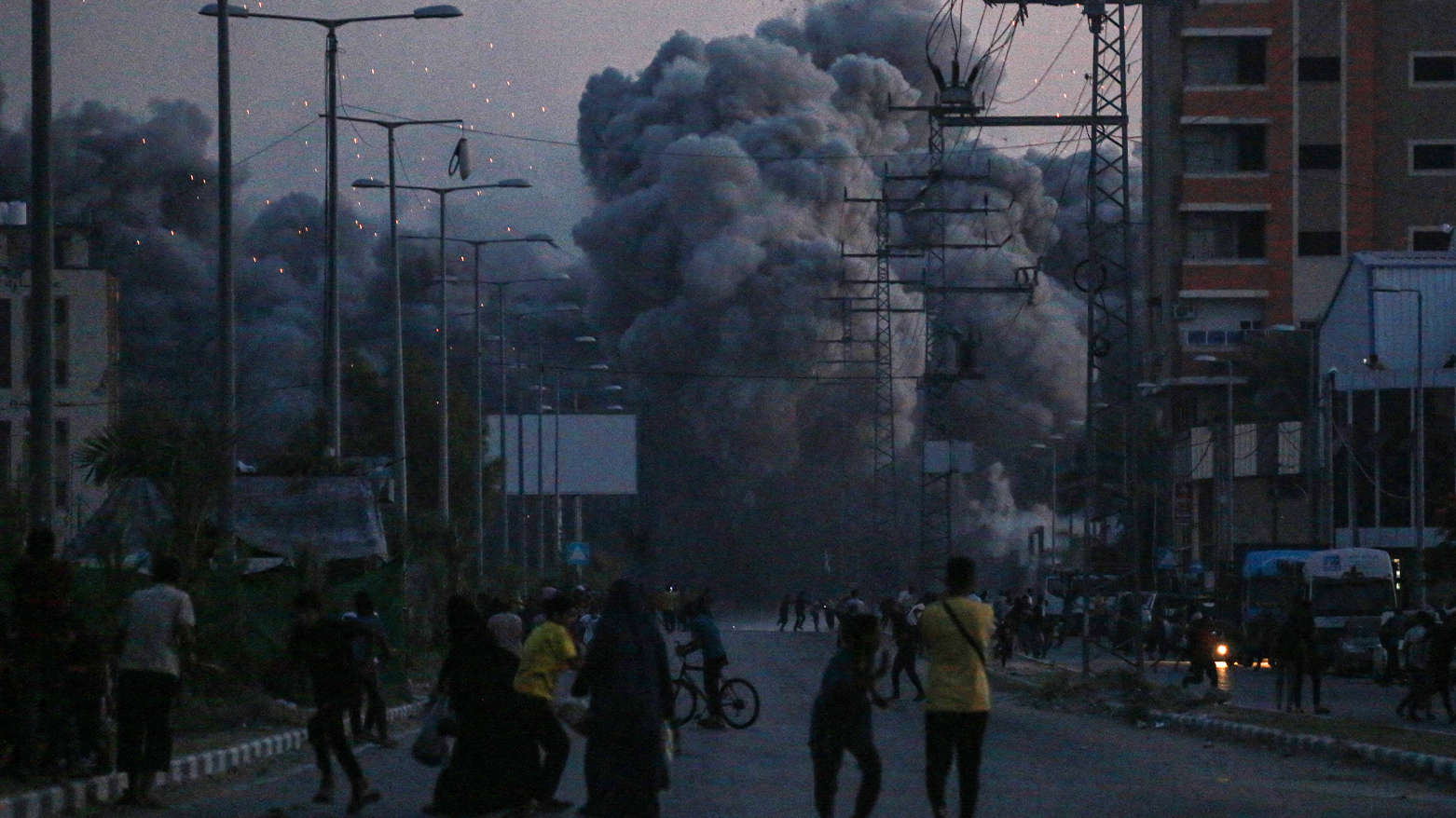 Palestinians watch smoke billowing following an Israeli airstrike in Deir al-Balah in the central Gaza Strip on June 6, 2024, amid the ongoing conflict between Israel and the Palestinian militant group Hamas. (Photo: Bashar TALEB / AFP)