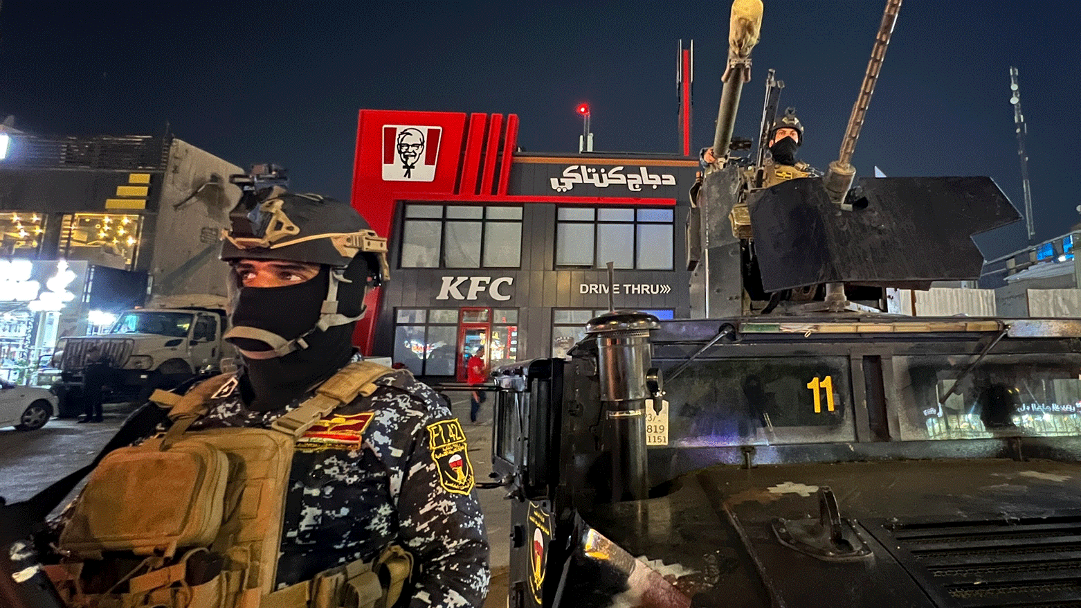 Iraqi security forces stand guard in front of Kentucky Fried Chicken restaurant in Baghdad, Wednesday, June 5, 2024. (Photo: AP)