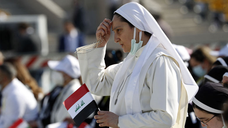 A nun makes the sign of the cross while praying as she awaits the arrival of Pope Francis at the Franso Hariri Stadium in Erbil, Kurdistan Region, March 7, 2021. (Photo: Safin Hamed / AFP)