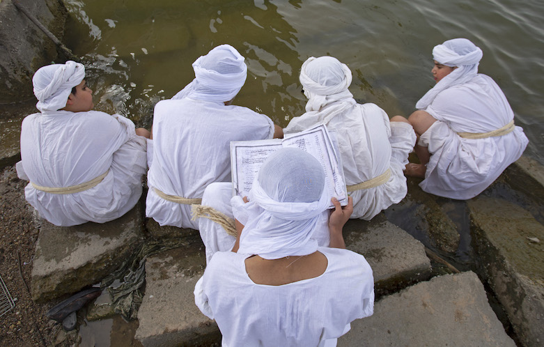 Followers of the Mandaeism religion gather near the Shatt Al-Arab river, in the southern Iraqi city of Basra on March 18, 2021, to mark the holiday Eid Al-Khalqeh. (Photo: Hussein FALEH / AFP)