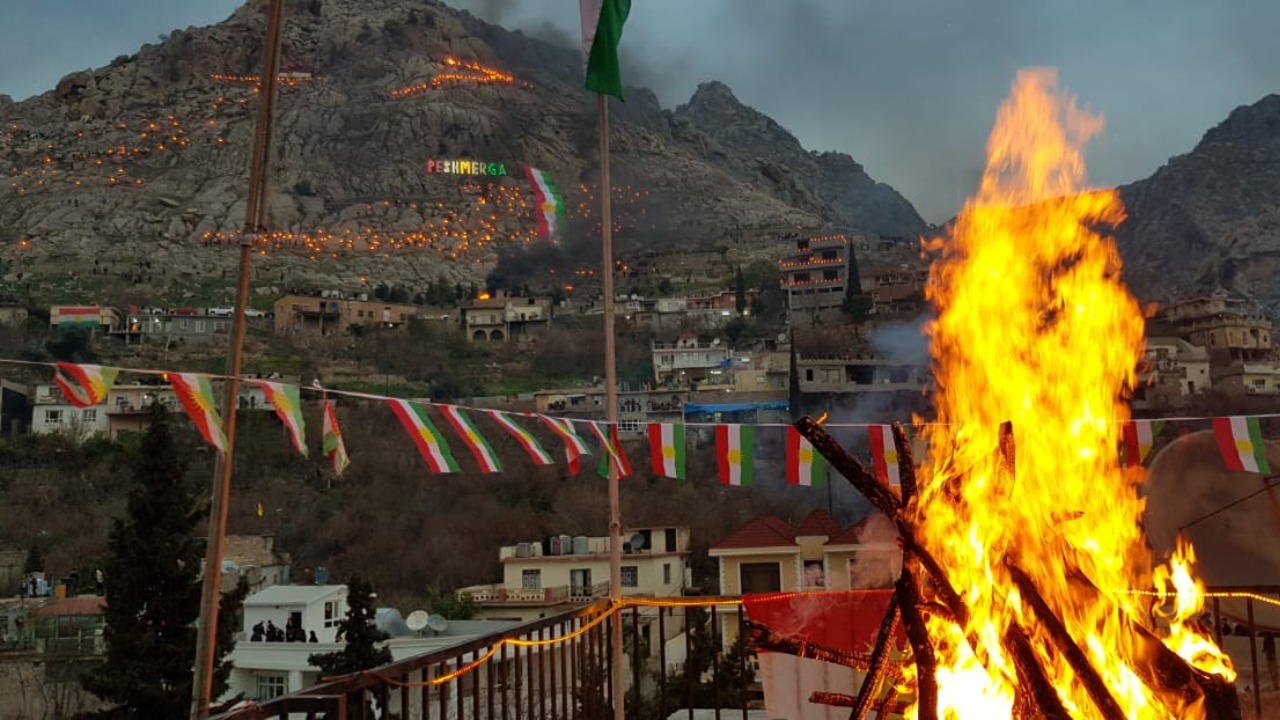 Hundreds of people carrying fiery torches climb up the Kale mountaintop, located in Akre, a town in Kurdistan Region's Duhok province popularly referred to as the capital of Newroz, the Kurdish New Year. (Photo: Wladimir van Wilgenburg)