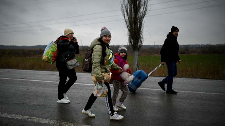 Refugees from Ukraine walk on a road after crossing the Moldova-Ukrainian border's checkpoint near the town of Palanca, March 1, 2022. (Photo: Nikolay Doychinov/AFP)