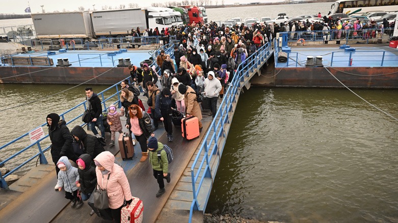 People coming from Ukraine descend from a ferry boat to enter Romania after crossing the Danube river at the Isaccea-Orlivka border crossing between Romania and Ukraine, Feb. 26, 2022. (Photo: Daniel Mihailescu/AFP)