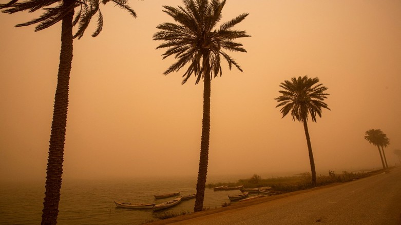 Fishing boats are pictured during a sand storm in Iraq's southern port city of Basra, March 4, 2022. (Photo: Hussein Faleh/AFP)