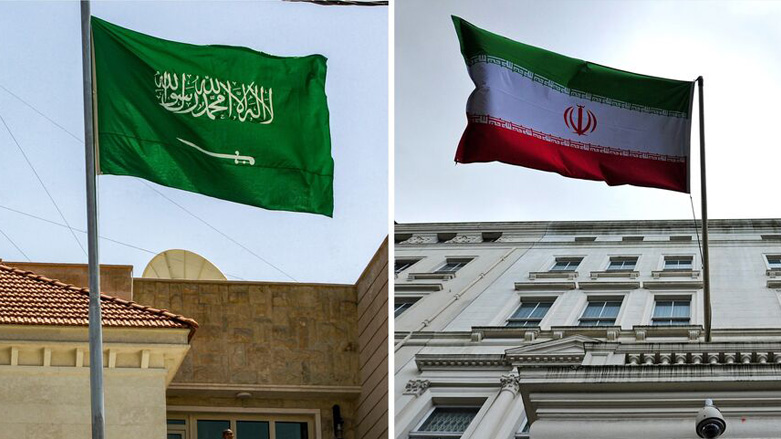 A Saudi flag (L) flies at the new Saudi Consulate headquarters in Baghdad, April 4, 2019, while the Iranian flag (R) hangs outside the Iranian Embassy in London, Feb. 20, 2014. (Photo: Carl Court/AFP)