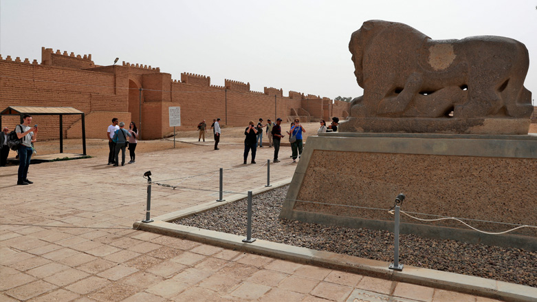 Visitors gather around the statue of the Lion of Babylon at the ancient city of the same name in Hilla, March 7, 2022. (Photo: Ahmad al-Rubaye/AFP)