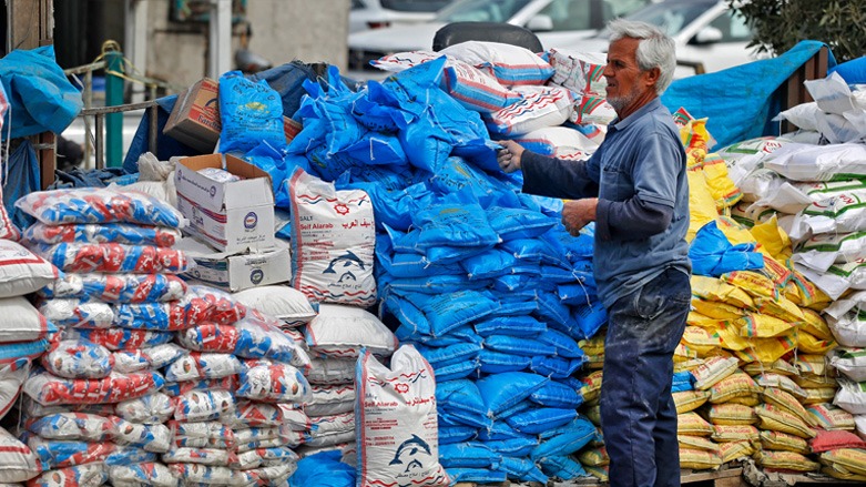 An Iraqi man arranges stacks sacks of salt at Jamila market in Iraq's capital Baghdad on March 8, 2022. (Photo: Ahmad al-Rubaye/AFP)