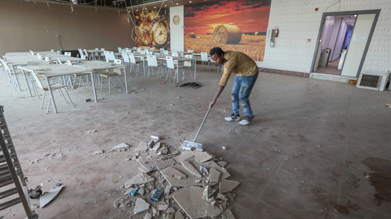 A man cleans debris in the damaged studios of the Kurdistan 24 TV building after a dozen ballistic missiles fell nearby in Kurdistan Region Erbil, March 13, 2022. (Photo: Safin Hamed/AFP)