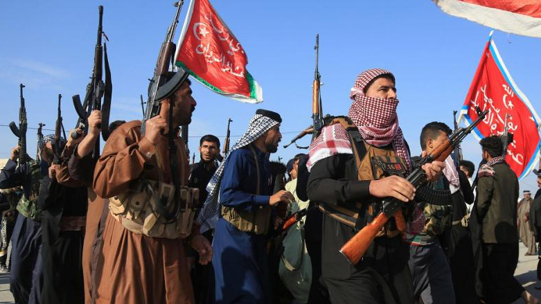 A number of armed tribesmen during a parade in Iraq. (Photo: AFP)