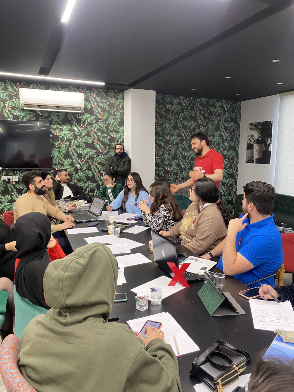 Young volunteers discussing the preparations for the fifth round of TEDxNishtiman in Erbil. (Photo: TEDxNishtiman)