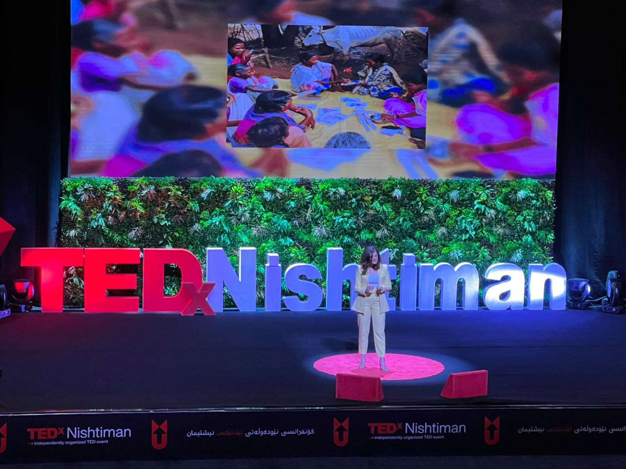 Goshan Karadaghi delivers her speech at fifth TEDxNishtiman on the importance of effective communications for tackling health issues, March 26, 2022. (Photo: Kurdistan 24)