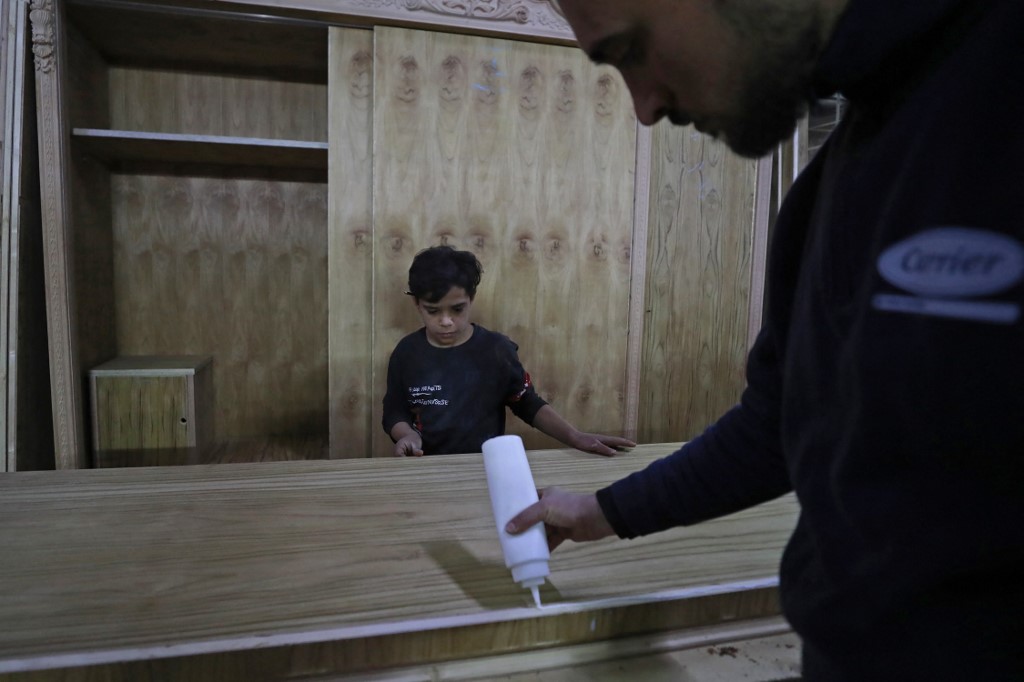 Haydar Karar works at a carpentry shop since age eight, in the capital Baghdad, Jan. 31, 2023. (Photo: Ahmad Al-Rubaye/AFP)