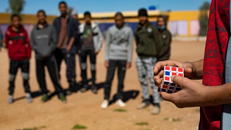 One of children of foreign Islamic State (IS) fighters holds a Rubik's cube while standing in a playground at the Orkesh rehabilitation centre in the countryside of Qamishli in northeastern Syria on March 7, 2023. (Photo: Delil Souleiman/ A