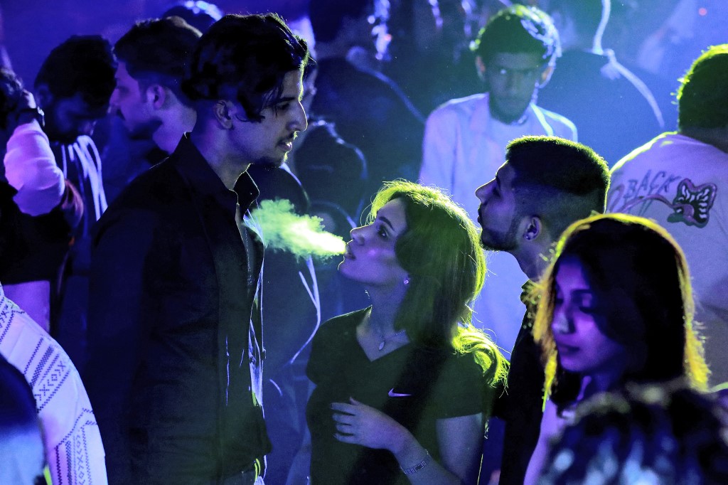 Youths attend the third edition of the Western Music Festival in Baghdad, March 10, 2023. (Photo: Murtaja Lateef/AFP)