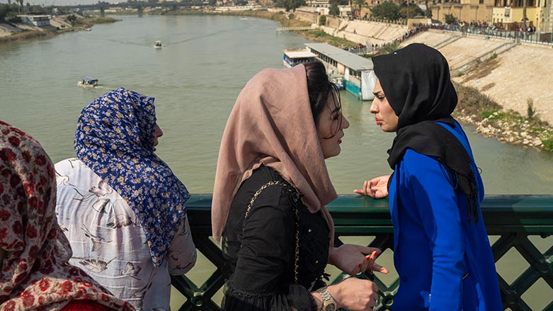 Women stand on the "martyrs' bridge" spanning the Tigris River in Baghdad, Iraq, Friday, Feb. 24, 2023. (Jerome Delay/ AP)