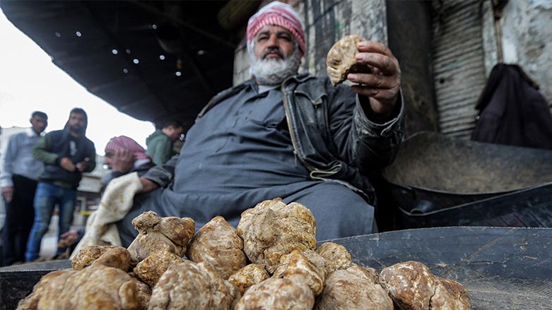 a merchant presents a desert truffles at a market in the city of Hama in west-central Syria on March 6, 2023. (Photo: Louai Beshara/AFP)