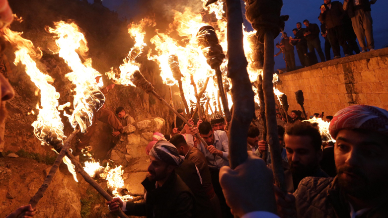 Hundreds of Kurdish people lit torches and walked up Mount Kale in celebration of the Kurdish new year in Akre, known as the capital of Newroz, on Sunday evening (Photo: Safin Hamed/AFP)