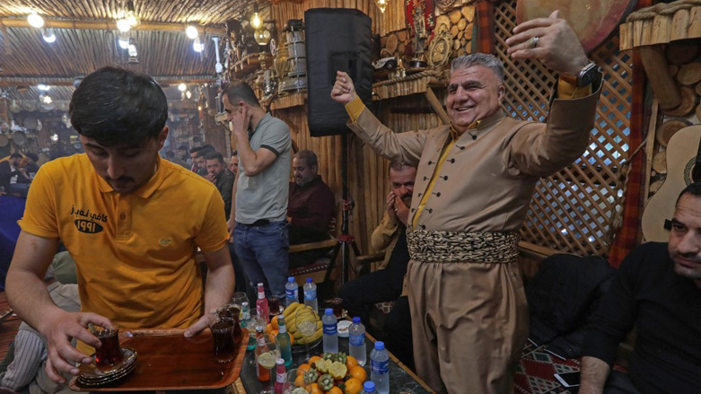 Nabaz Chawshin (right) dancing at his cafe in Ta'jil, a popular neighborhood of the Kurdistan Region's capital, March 26, 2023. (Photo: Safin Hamed/AFP)