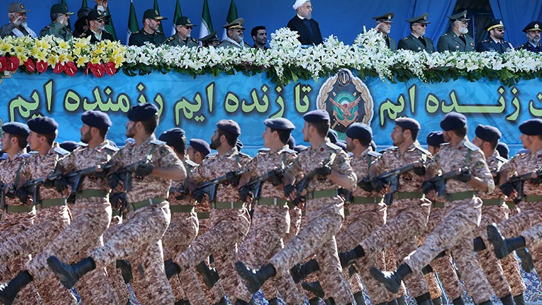 Iran's President Hassan Rouhani, top center, reviews army troops marching during a parade marking National Army Day in Tehran, Iran, Sunday, April 17, 2016. (Photo: Ebrahim Noroozi/ AP)