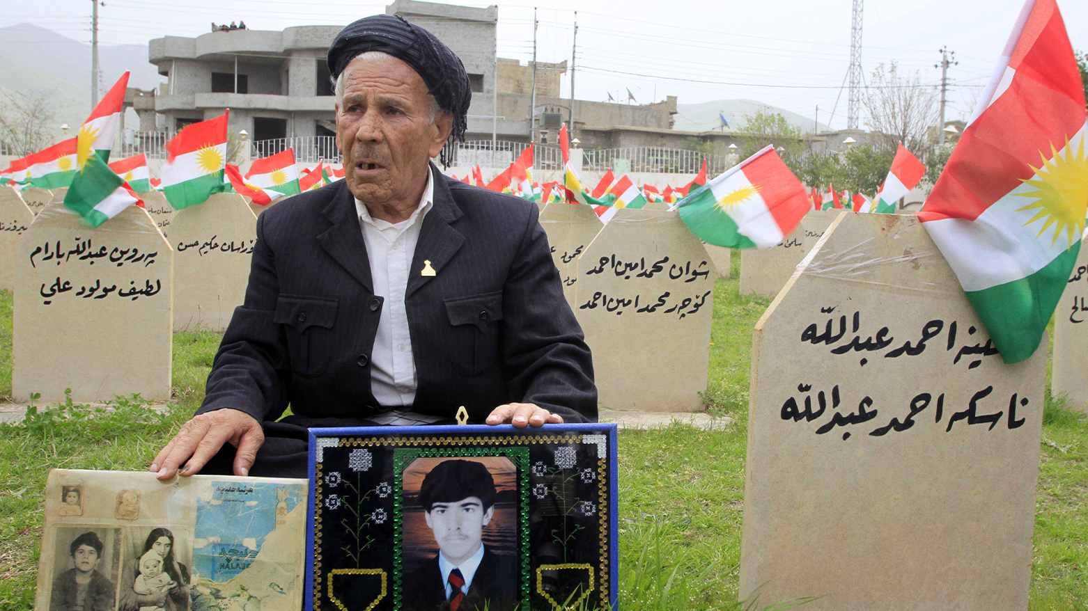 The photo shows Mohammed Abdullah, 57, holding pictures of his family members killed in the 1988 chemical attack during a memorial service in Halabja, Iraq. (Photo: AP/Yahya Ahmed)