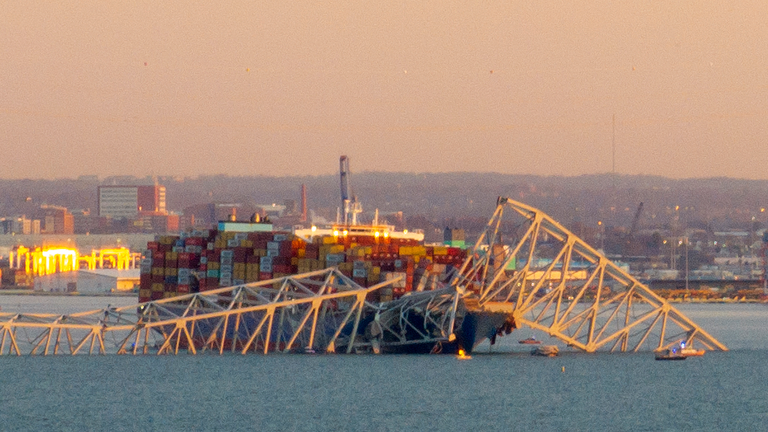 The steel frame of the Francis Scott Key Bridge sits on top of a container ship after it struck the bridge in Baltimore, Maryland, on March 26, 2024. (Photo: ROBERTO SCHMIDT/AFP)