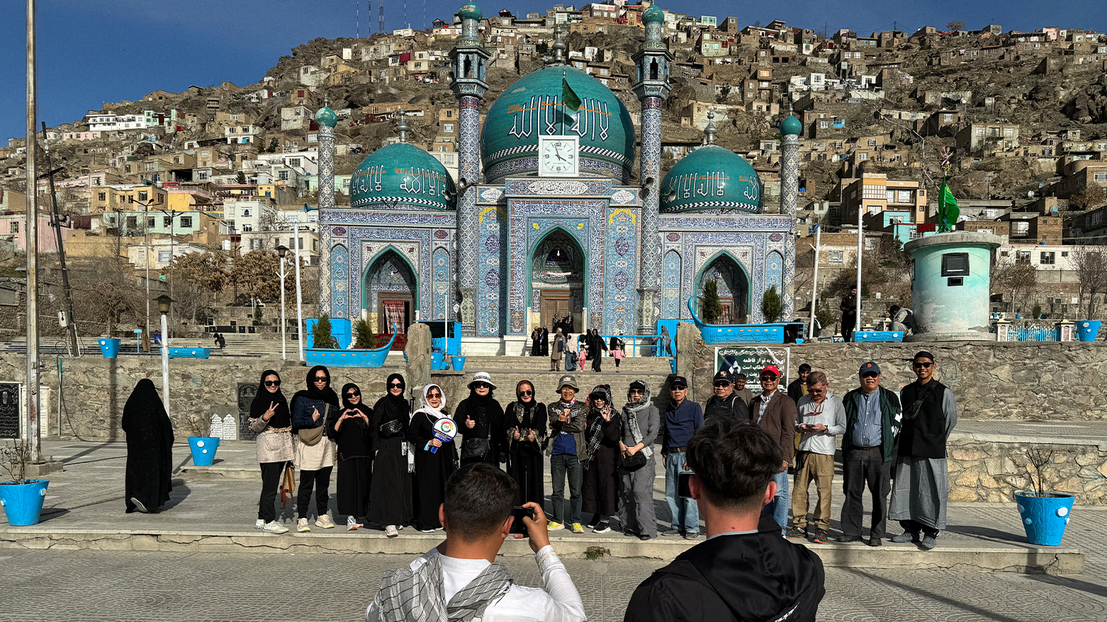 In this picture Thai tourists pose for a group picture during their visit to the Kart-e-Sakhi Shrine in Kabul. (Photo: WAKIL KOHSAR/AFP)