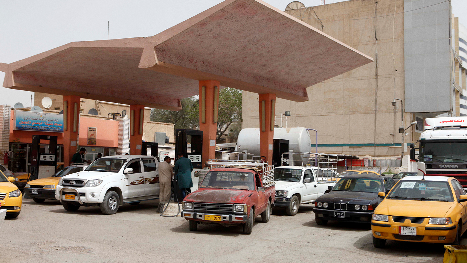 Iraqis fill up at a gas station in Baghdad, Iraq. (Photo: AP/Karim Kadim)
