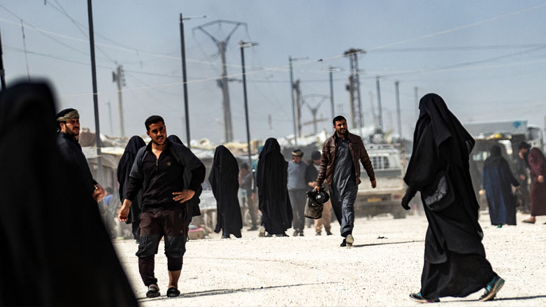 People walk at the Kurdish-run al-Hol camp which holds suspected relatives of ISIS fighters, in Hasakeh governorate in northeastern Syria, March 3, 2021. (Photo: Delil Souleiman / AFP)