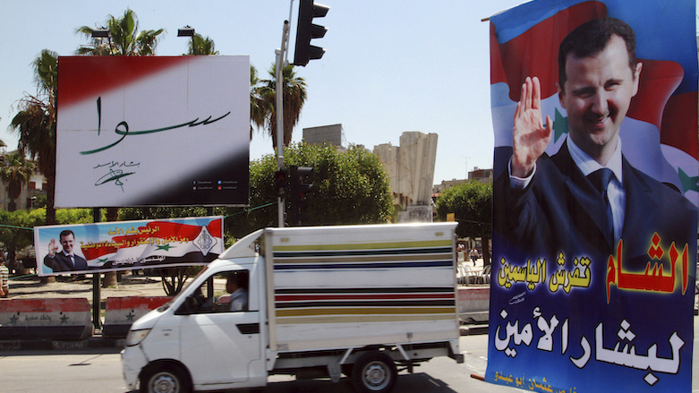 In this May 12, 2014 file photo, campaign posters for the upcoming presidential election adorn a street in Damascus, Syria. The banner reads, “Together with Bashar Assad.” (Photo: AP/File)