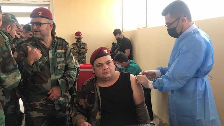 A member of the Kurdistan Region's Peshmerga forces on Pirde Front is pictured while receiving the first shot of coronavirus vaccine, May 10, 2021. (Photo: Hoshmand Sadiq / Kurdistan 24)