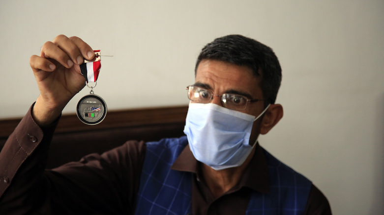 Ayazudin Hilal, a former Afghan interpreter for the US, holds his medal during an interview in Kabul, Afghanistan on April 30, 2021. (Photo: Mariam Zuhaib/AP)