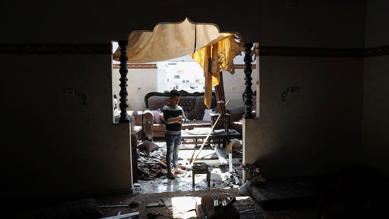 A child looks at the damaged room of his family apartment after by Israeli airstrikes near a residential building, in Beit Lahiya, Gaza Strip, May 20, 2021. (Photo: Adel Hana/AP)