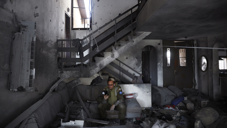 An Israeli soldier from the IDF Spokesperson's Unit inspects the damaged house after it was hit by a rocket fired from the Gaza Strip, in Ashkelon, Israel, May 20, 2021. (Photo: Ariel Schalit/AP)