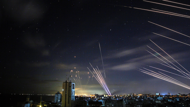 In the background the Iron Dome missile sense system (L) intercepts rockets (R) fired by Hamas towards Israel from Gaza, and on foreground tens of other intercepts rockets while the Iron Dome is busy, May 16, 2021. (Photo: Anas Baba/AFP)