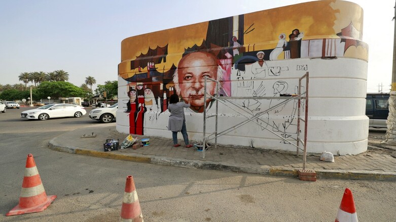 Iraqi artist Wijdan al-Majed draws a mural depicting Iraqi poet Muzzafar al-Nawab on a concrete structure in the capital Baghdad, April 26, 2022. (Photo: Ahmad Al-Rubaye/AFP(