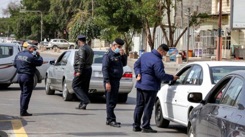 Police officers stop vehicles at a checkpoint in the Karrada district of Iraq's capital Baghdad on March 14, 2021, as they enforce a total curfew imposed to curb COVID-19 coronavirus cases. (AFP)